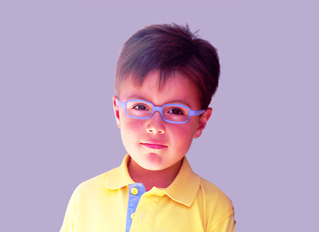 A young boy wearing glasses and a yellow shirt.